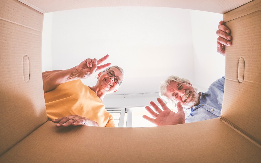 senior couple opening a moving box