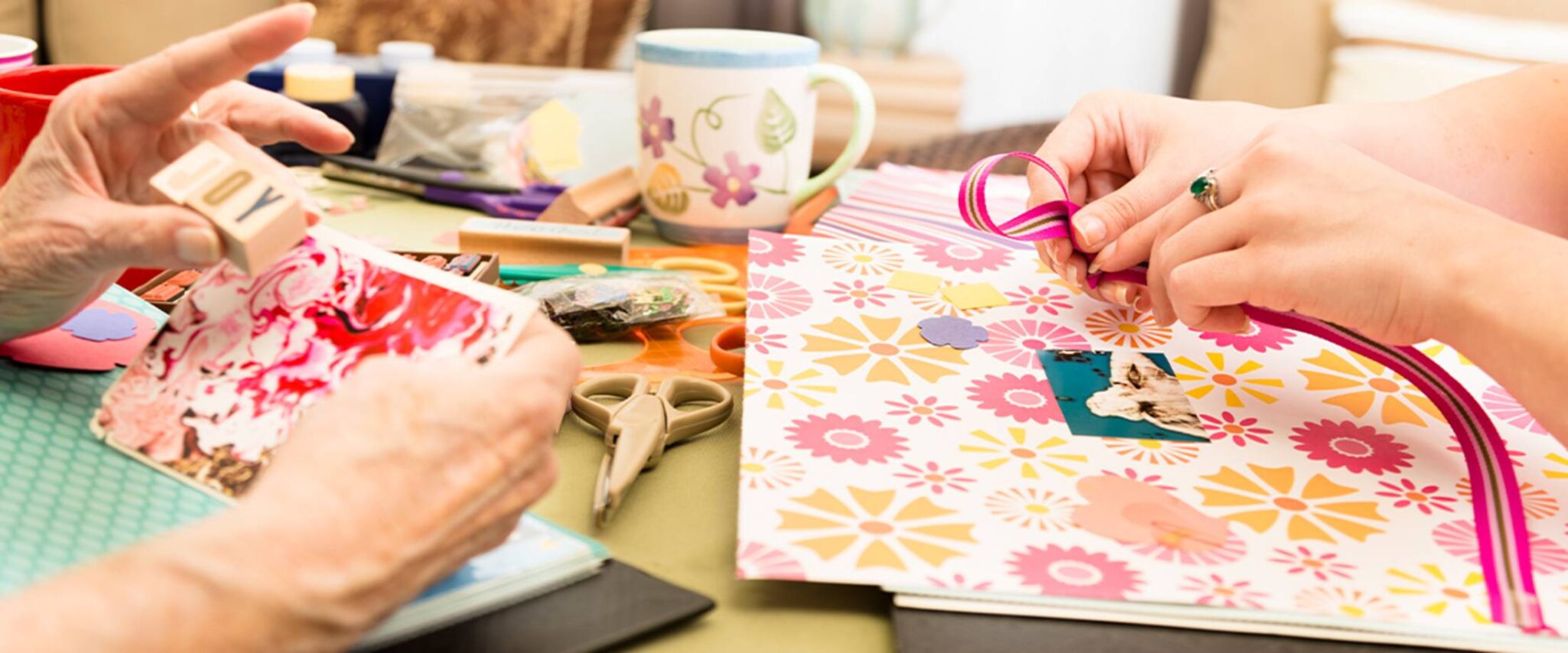 A senior and their adult child making crafts together