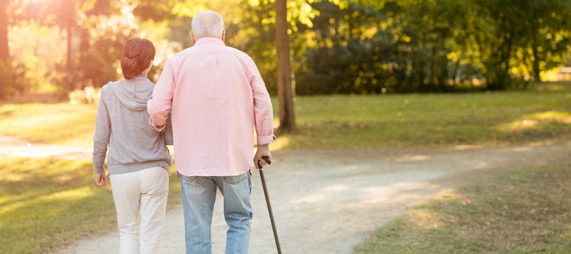 Senior couple on a walk outside Freedom Pointe retirement community