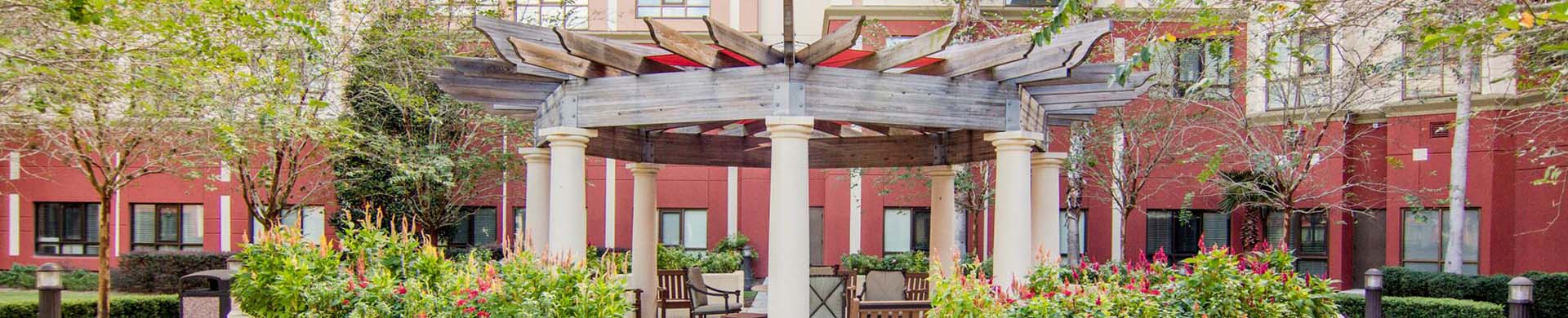Outdoor seating area under the pergola at Freedom Pointe at the Villages 