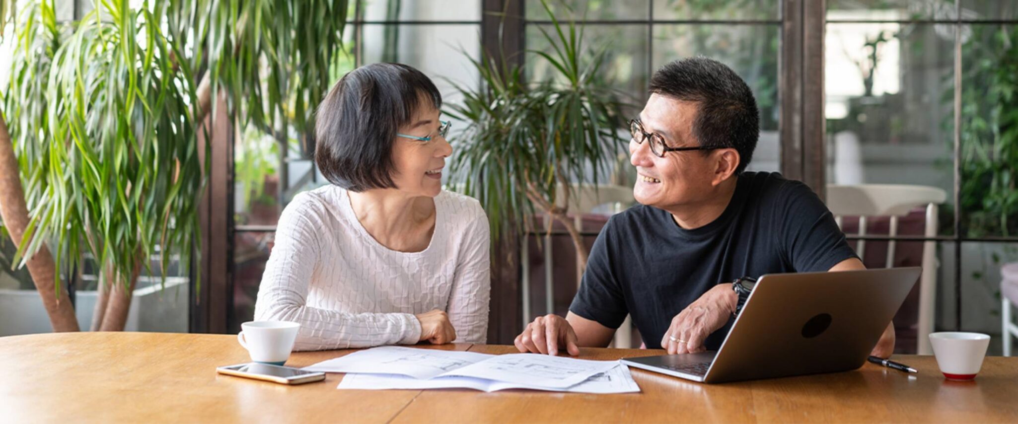 Senior couple talking and looking at paperwork