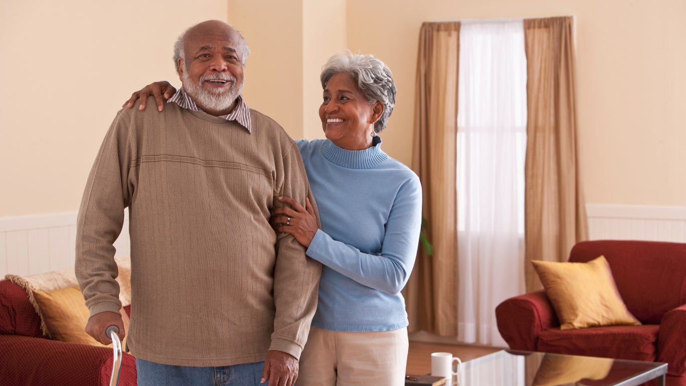 Senior couple smiling inside home