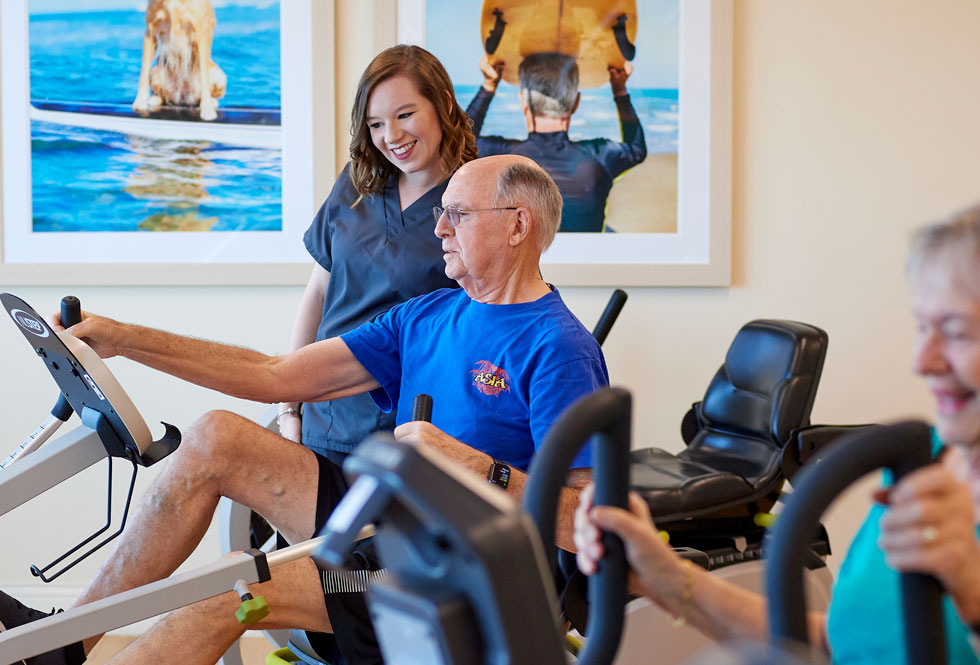 A senior man exercising on a stationary bike.