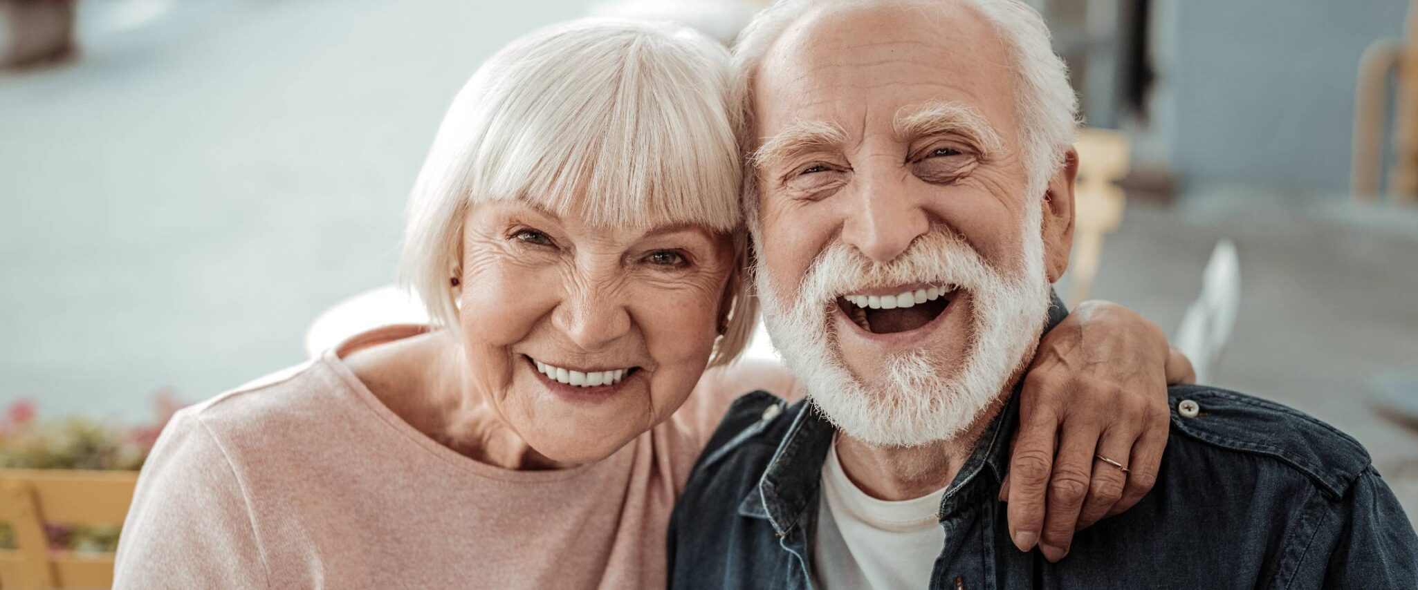 senior couple in senior living smiling and laughing at the camera