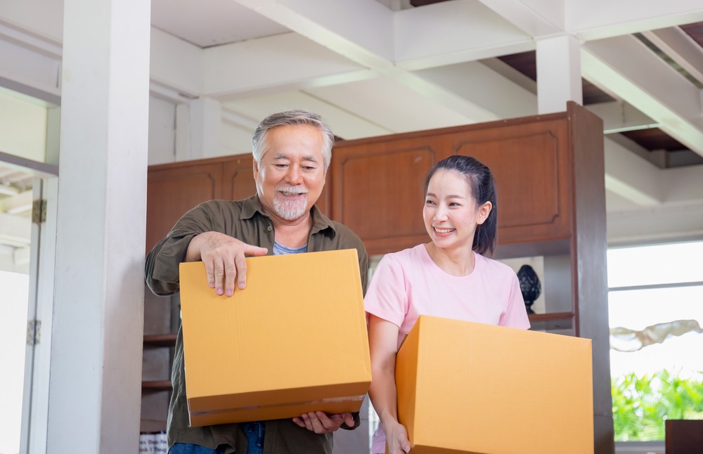 Daughter helping her senior father move out