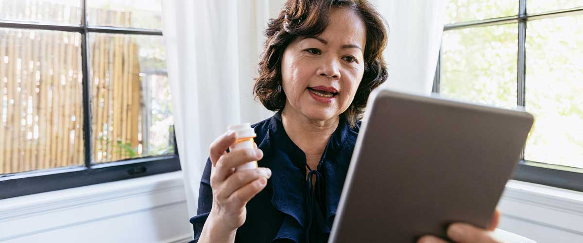 Senior woman video chatting with her doctor