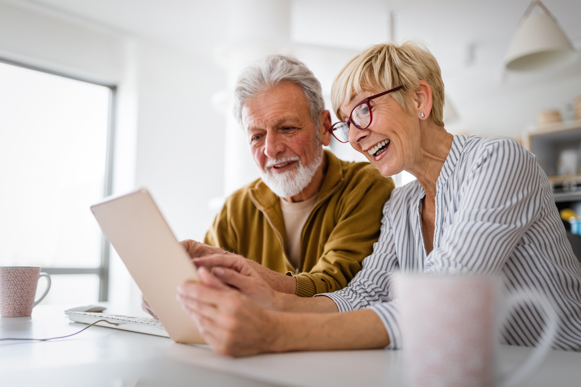 Happy senior couple looking at a tablet