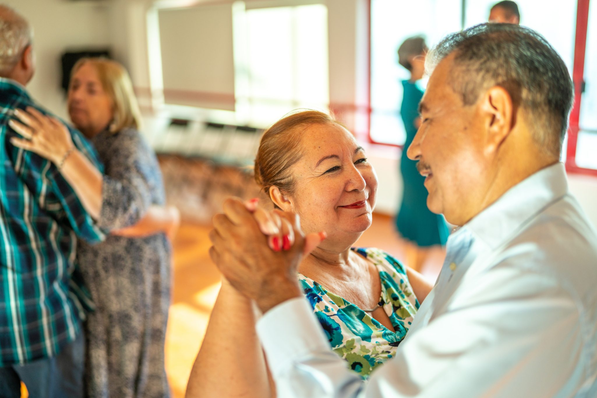 Group of senior friends dancing in dance studio