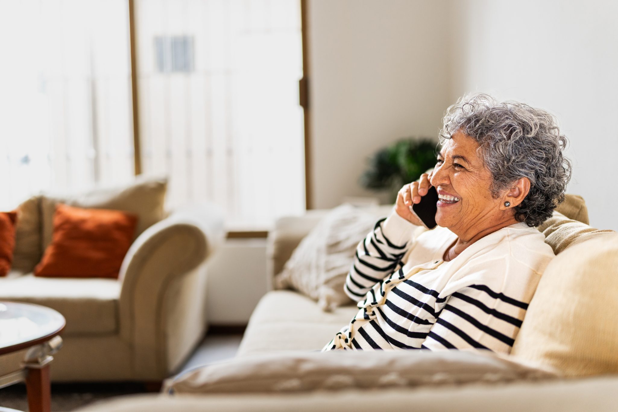 Smiling senior woman talking on mobile phone