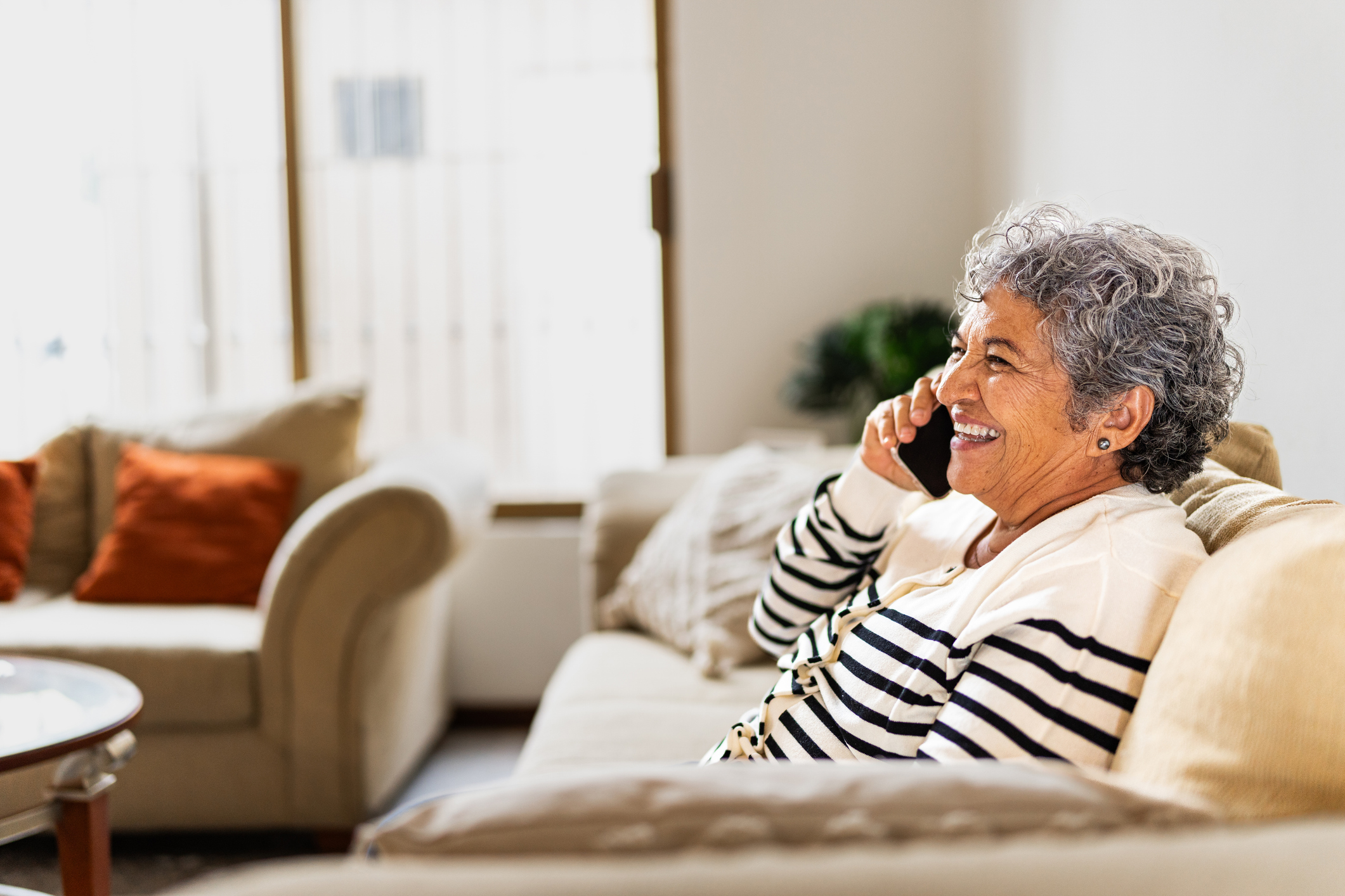 Smiling senior woman talking on mobile phone