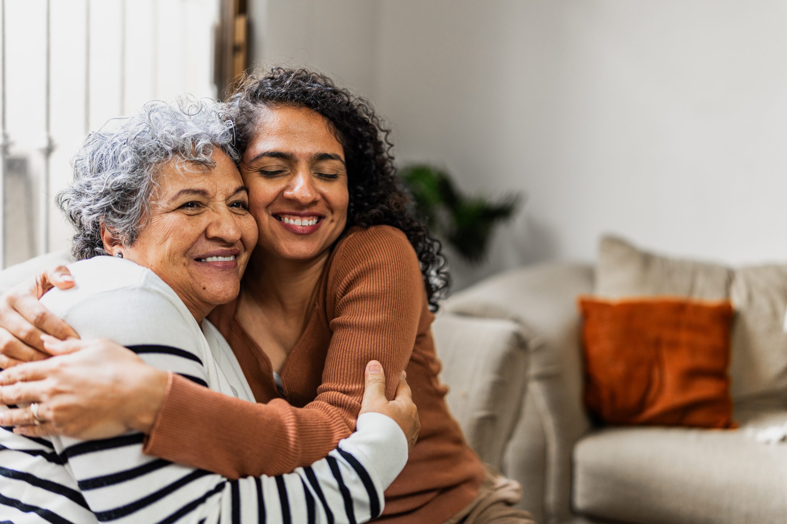 Senior woman embracing adult daughter